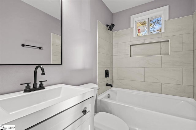 full bathroom featuring vanity, toilet, and tiled shower / bath