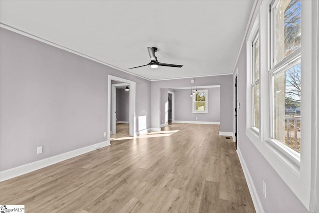 unfurnished living room featuring ceiling fan, light wood-type flooring, and crown molding