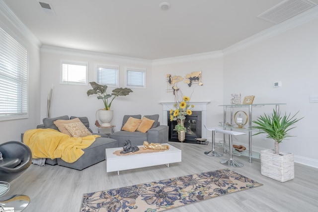 living room featuring light hardwood / wood-style flooring and ornamental molding