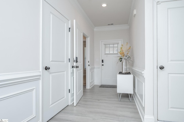 corridor with crown molding and light wood-type flooring