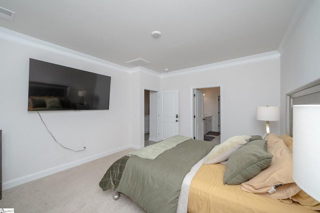 carpeted bedroom featuring ensuite bath and ornamental molding