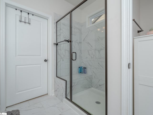 bathroom featuring a shower with door