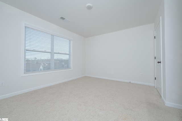 unfurnished room featuring light colored carpet