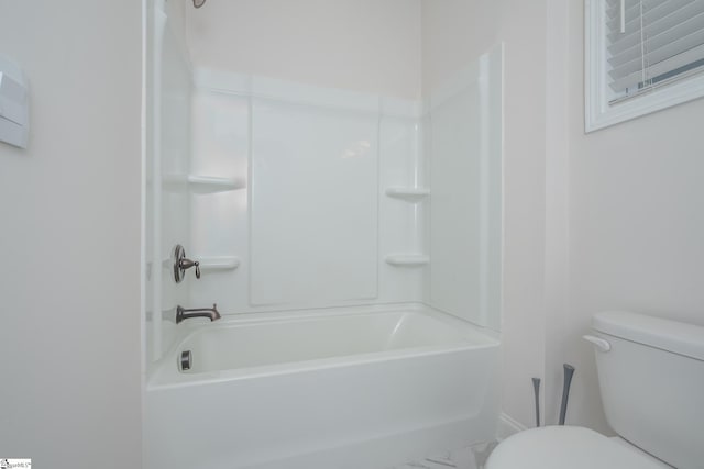 bathroom featuring shower / bathing tub combination and toilet