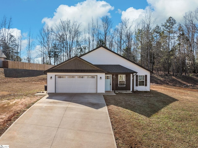 single story home featuring a garage and a front lawn