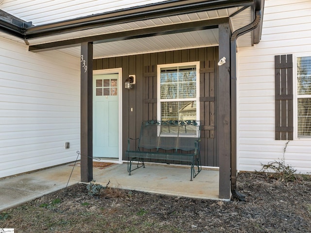 view of exterior entry featuring covered porch