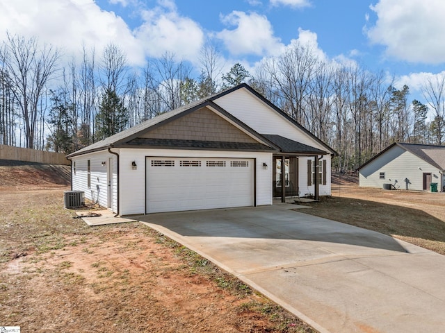 view of front of house with a garage and central AC