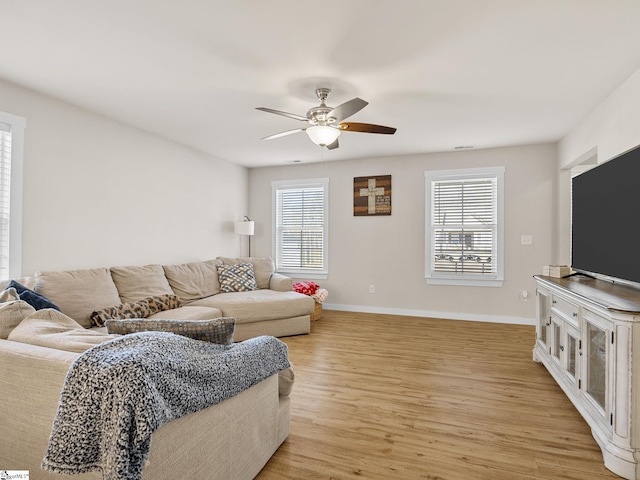 living room with ceiling fan, a healthy amount of sunlight, and light hardwood / wood-style flooring