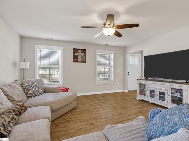 living room featuring ceiling fan and light hardwood / wood-style floors