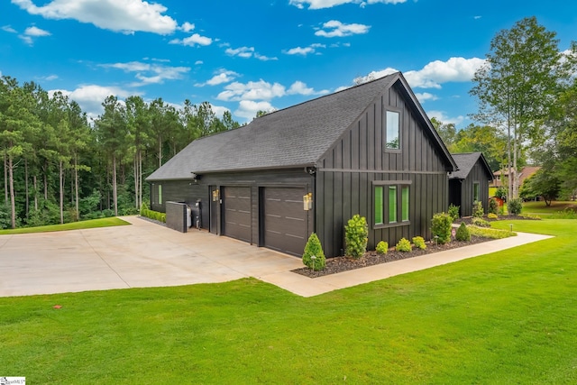 view of side of property with a lawn and an outbuilding