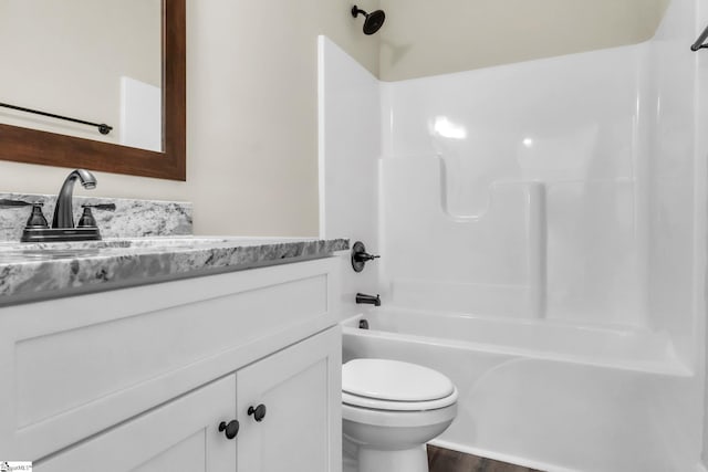 full bathroom featuring vanity, toilet, wood-type flooring, and bathing tub / shower combination