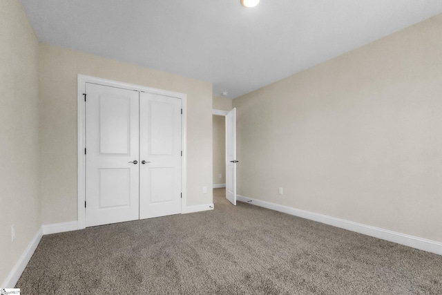 unfurnished bedroom featuring carpet floors and a closet