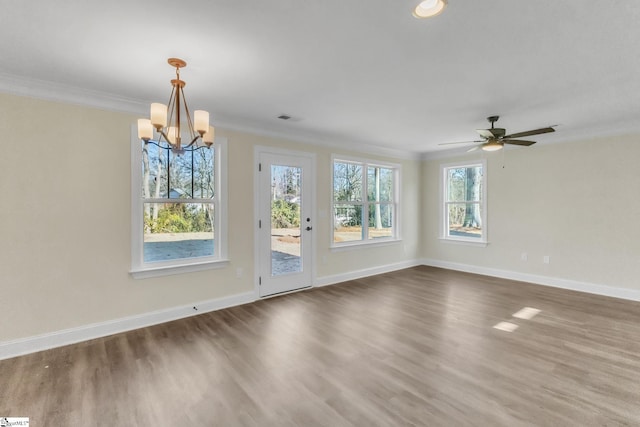 spare room featuring dark hardwood / wood-style flooring, a healthy amount of sunlight, and ornamental molding