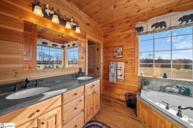 bathroom with wood ceiling, a bathing tub, and wood walls