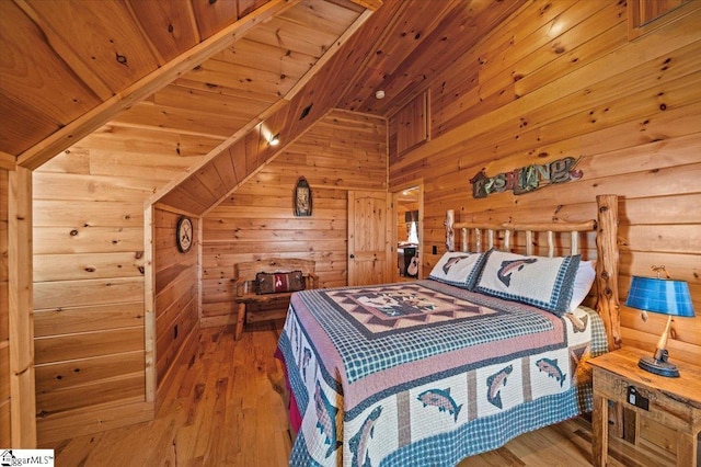 bedroom featuring wood walls, wood ceiling, and hardwood / wood-style flooring