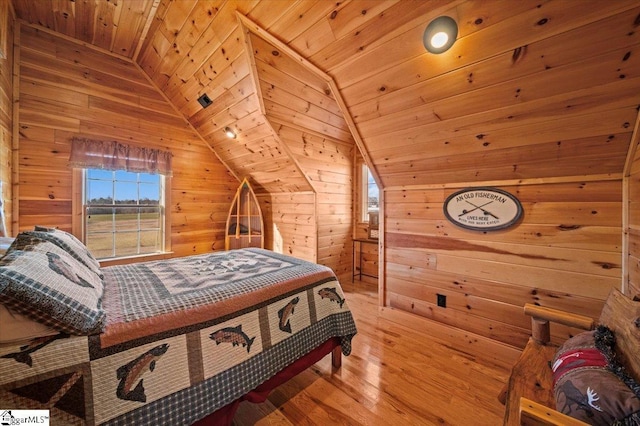 bedroom with hardwood / wood-style flooring, lofted ceiling, wood ceiling, and wooden walls