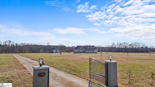 exterior space featuring a rural view and a lawn