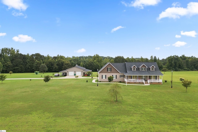 view of front of house with a garage, a porch, and a front yard