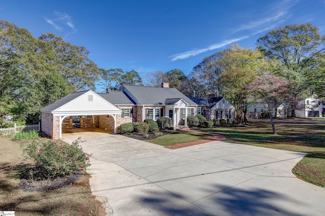 view of front facade with a carport and a front lawn