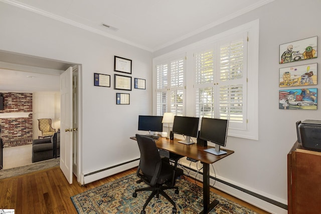 office space featuring baseboard heating, crown molding, hardwood / wood-style floors, and plenty of natural light