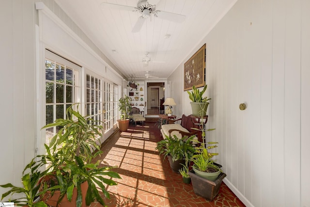 sunroom featuring ceiling fan