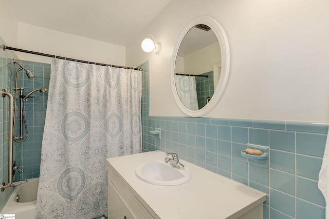 bathroom with vanity, tile walls, and shower / tub combo