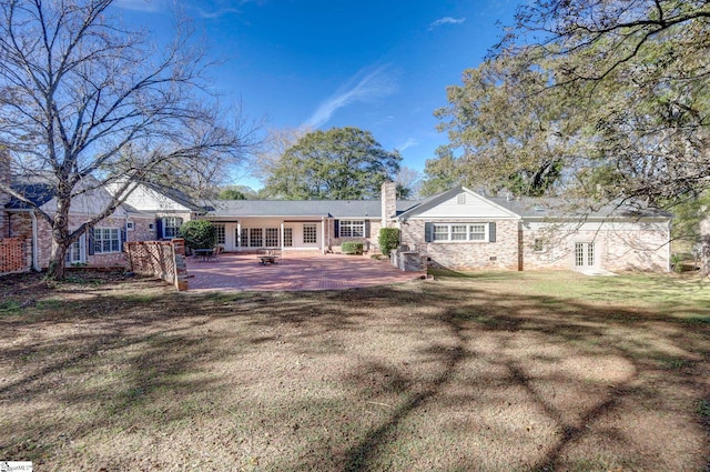 rear view of property with a lawn