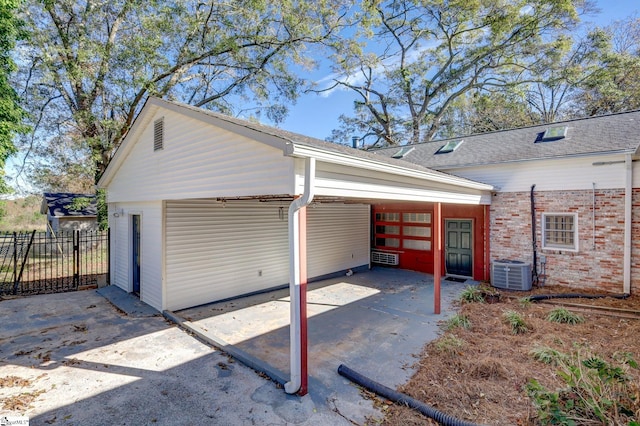 garage featuring a carport and cooling unit