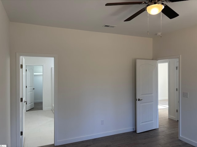 spare room with ceiling fan and dark hardwood / wood-style flooring