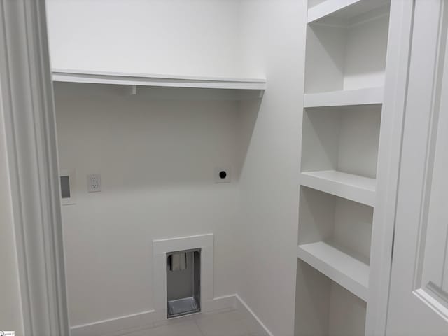 washroom featuring light tile patterned flooring and hookup for an electric dryer