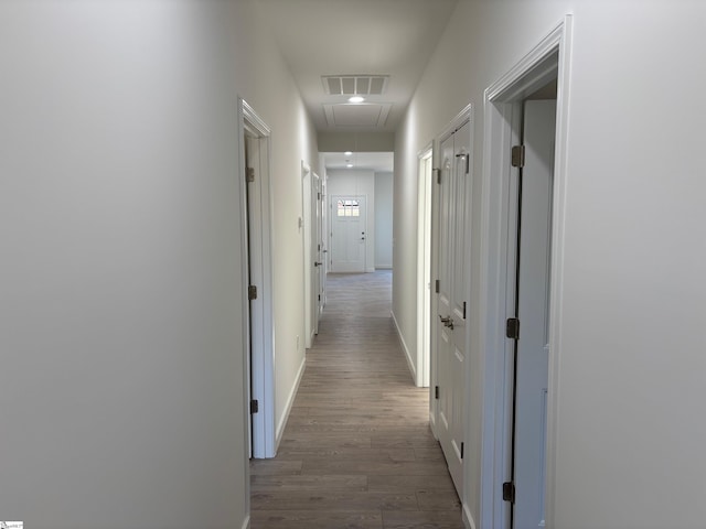 hallway with hardwood / wood-style flooring