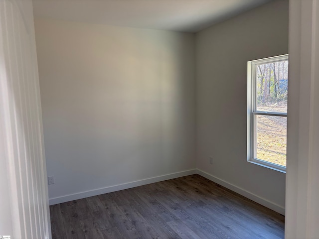 unfurnished room featuring dark hardwood / wood-style floors and a healthy amount of sunlight