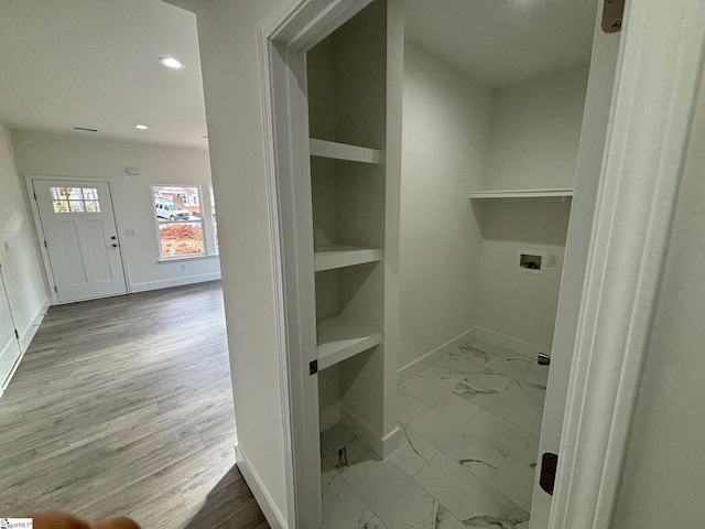 laundry room featuring built in shelves, recessed lighting, marble finish floor, and baseboards