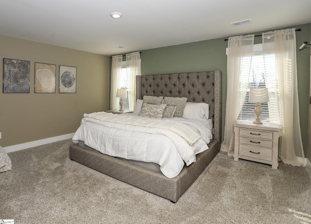 bedroom featuring carpet flooring and multiple windows