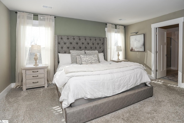 carpeted bedroom featuring multiple windows