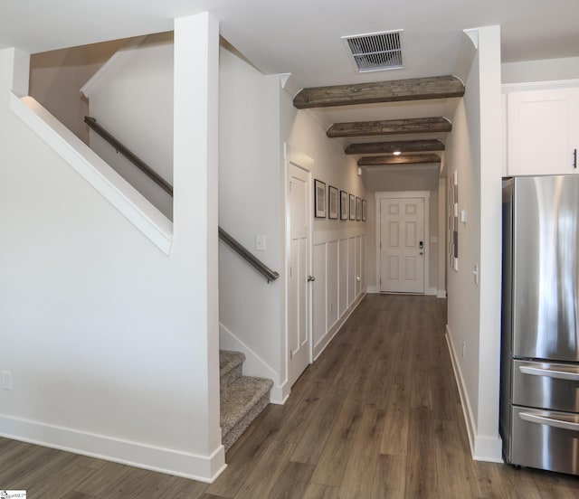 hall featuring beamed ceiling and dark wood-type flooring