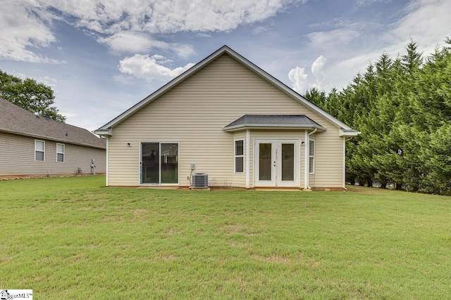 back of house featuring a lawn, french doors, and central AC unit