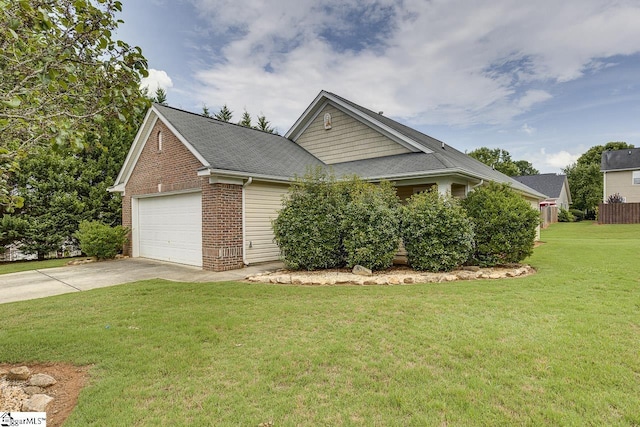 view of front of home featuring a front yard and a garage