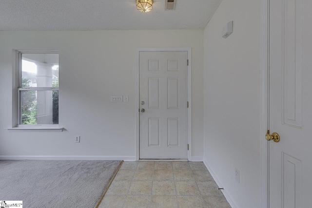 entrance foyer featuring a textured ceiling