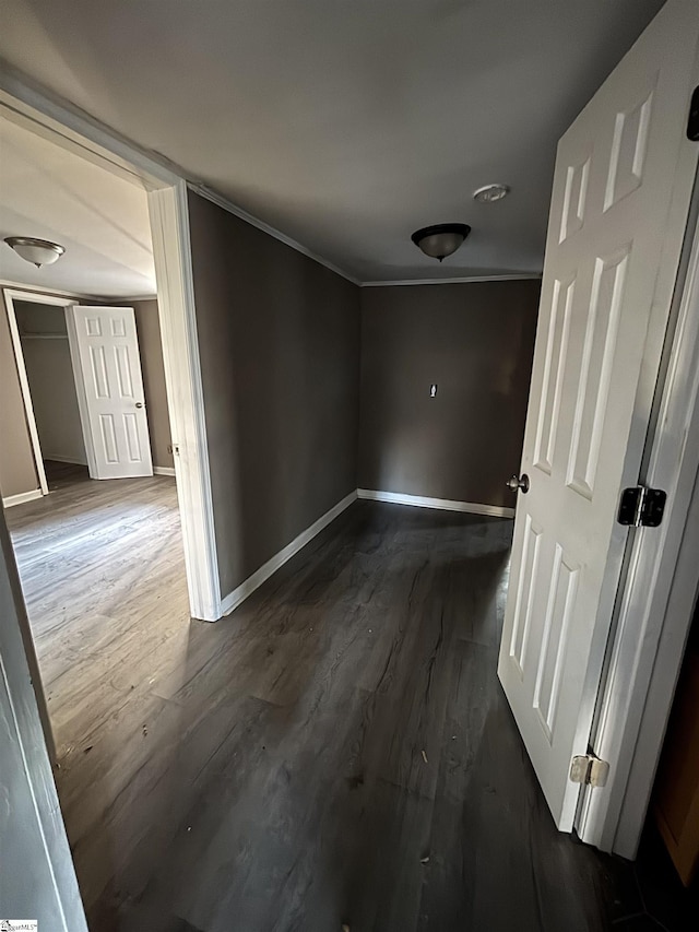 hall with dark hardwood / wood-style floors and ornamental molding