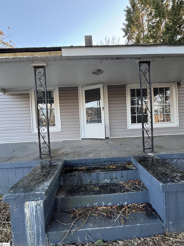 doorway to property featuring covered porch