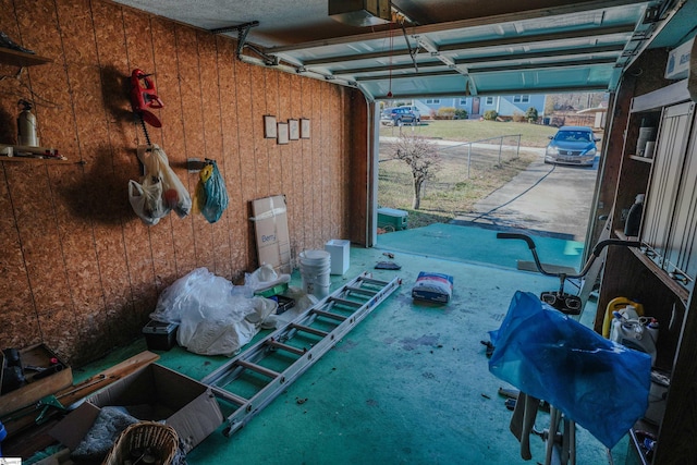 garage featuring wood walls and a garage door opener