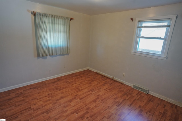 spare room with wood-type flooring