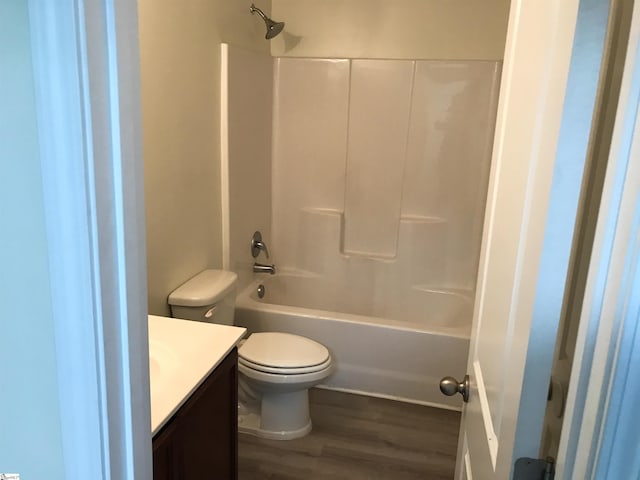 full bathroom featuring hardwood / wood-style floors, vanity, toilet, and shower / bathing tub combination