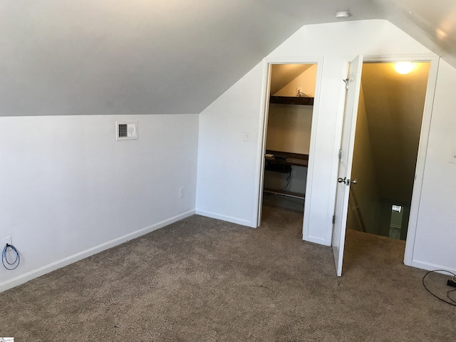 additional living space with carpet flooring and lofted ceiling