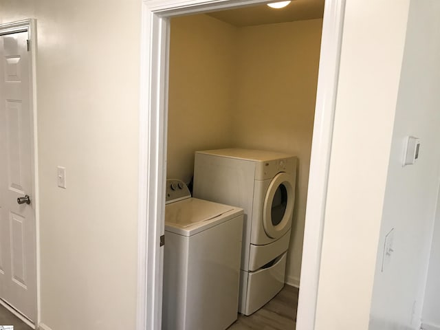 clothes washing area featuring independent washer and dryer and light wood-type flooring