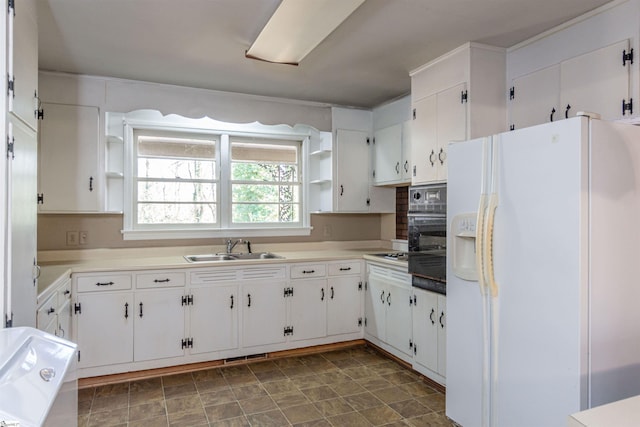 kitchen featuring white cabinetry, sink, oven, and white refrigerator with ice dispenser