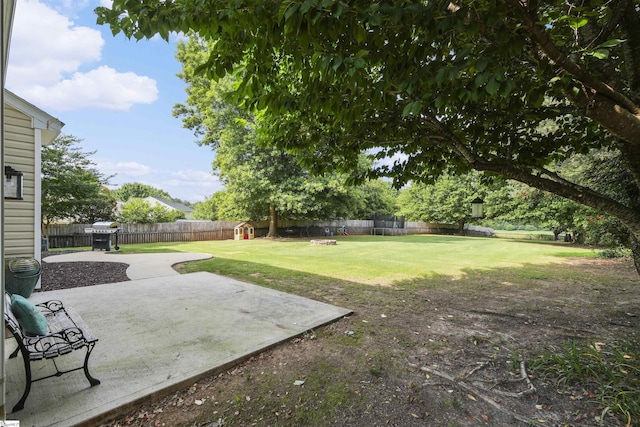 view of yard with a patio and an outdoor fire pit