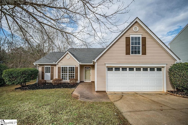 view of front of property featuring a front lawn and a garage