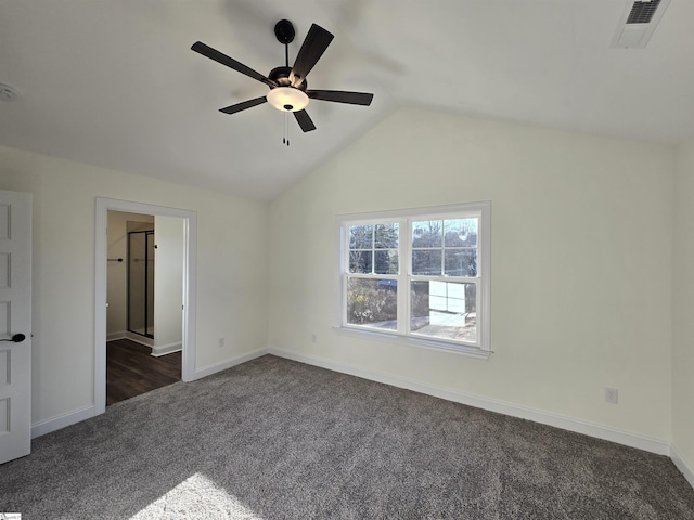 carpeted empty room featuring ceiling fan and vaulted ceiling